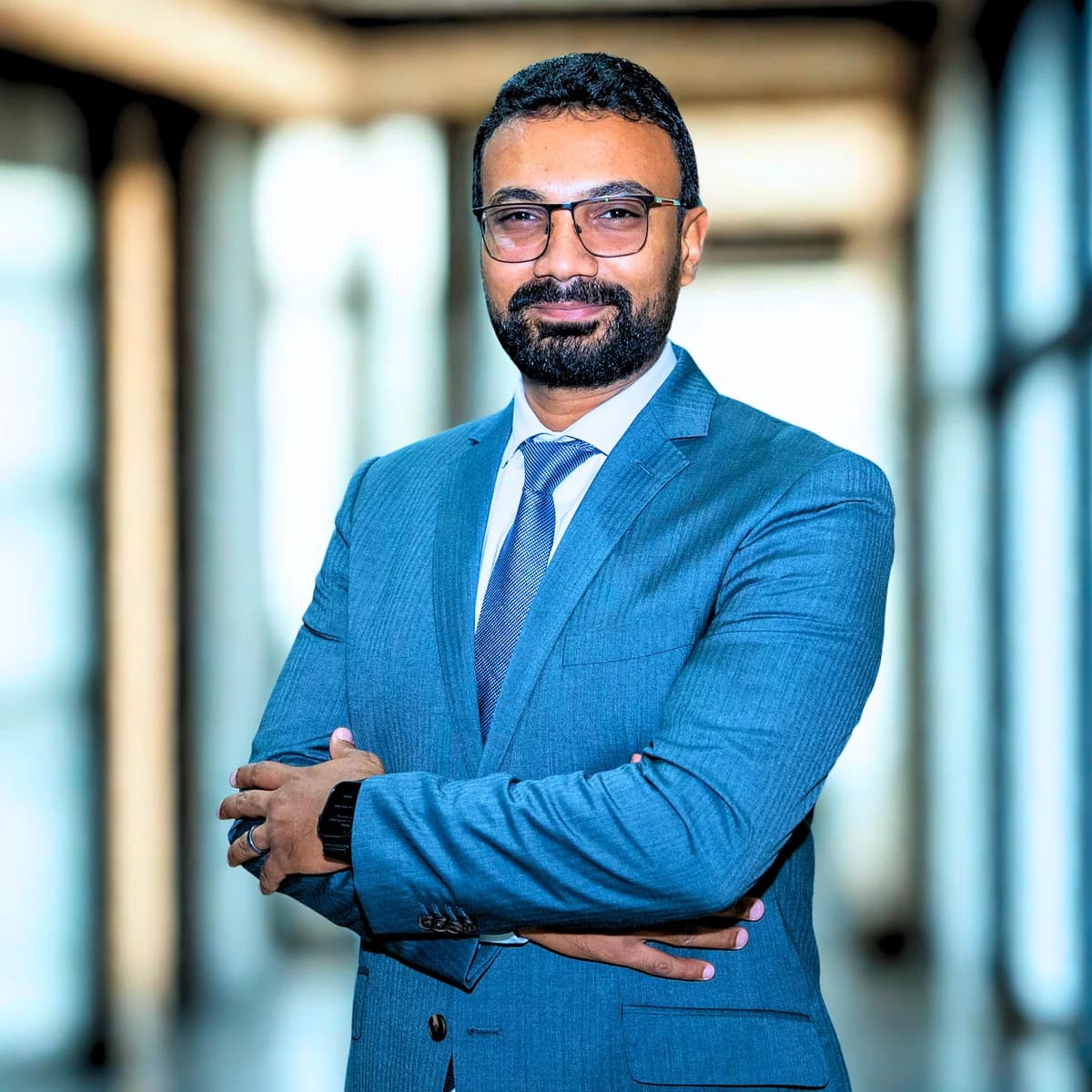 Ahmed Hassan Algammal, enterprise systems consultant at Faceela, in a blue suit with his arms folded.